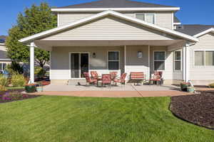 Back of property featuring a patio and a lawn