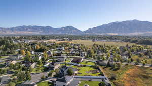 Aerial view of property's location featuring nearby suburban area and mountains