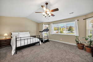 Bedroom with carpet, vaulted ceiling, and ceiling fan