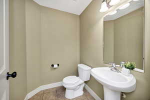 Bathroom featuring tile patterned floors and baseboards