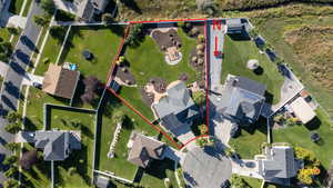 Aerial perspective of suburban area featuring property boundaries highlighted