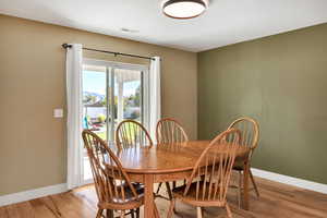 Dining space featuring baseboards and light wood-style floors