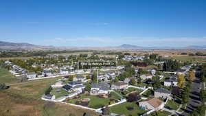 Aerial overview of property's location featuring nearby suburban area and mountains