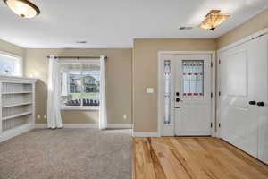 Foyer entrance with light wood-style flooring and baseboards