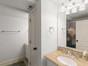 Full bathroom with vanity and a shower with shower curtain