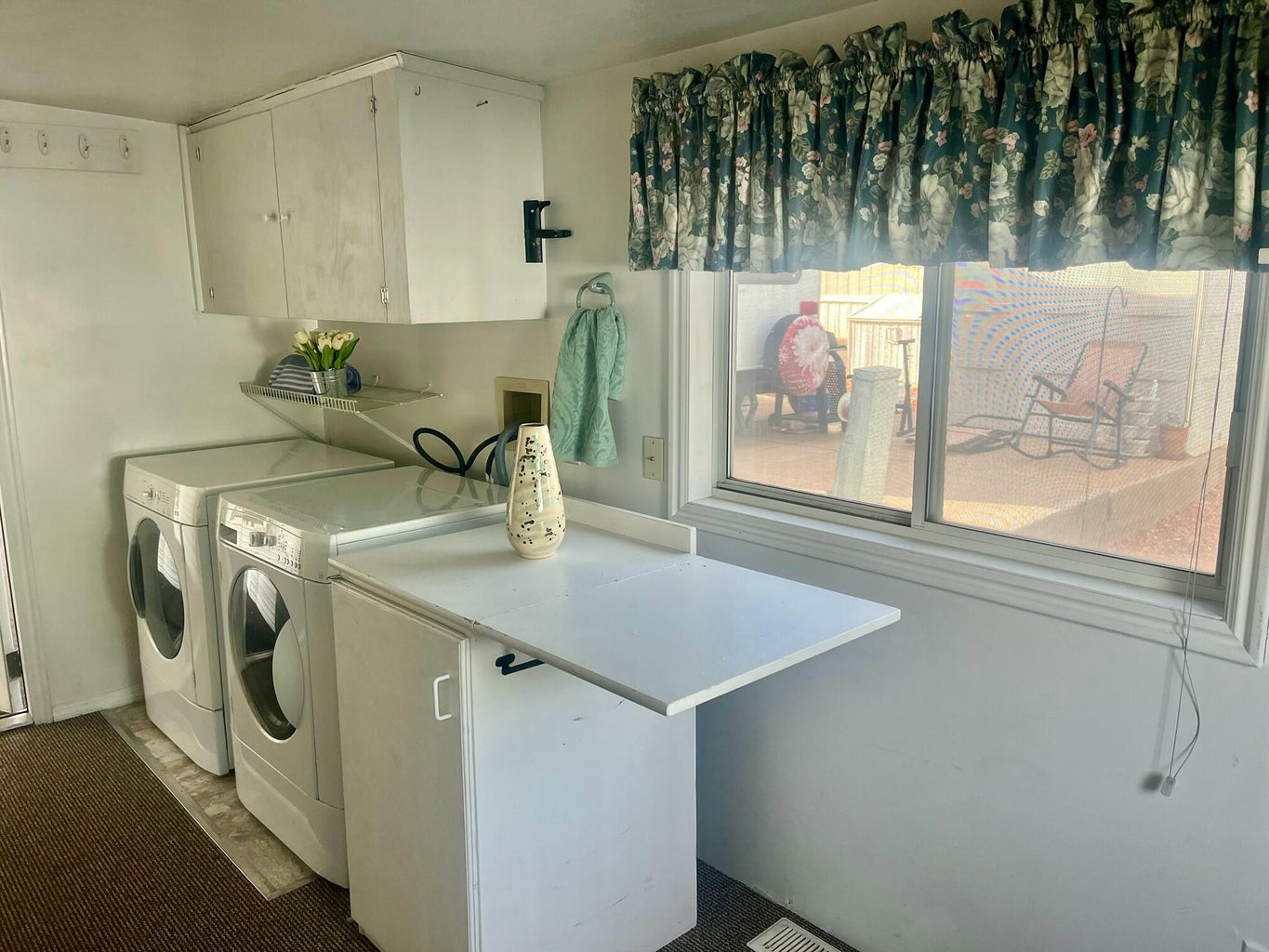 Laundry room featuring washer and clothes dryer and cabinet space