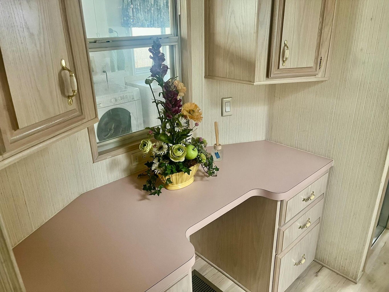 Detailed view of washer / clothes dryer and wallpapered walls