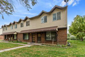 Traditional-style home with brick siding and a front yard