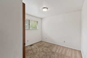 Unfurnished room featuring carpet and baseboards