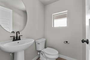 Bathroom with toilet and baseboards