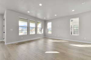 Unfurnished room with recessed lighting and light wood finished floors