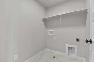 Washroom featuring hookup for an electric dryer, marble look tile flooring, and washer hookup