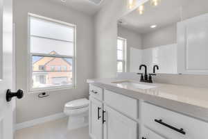 Bathroom featuring vanity, light tile patterned floors, and recessed lighting