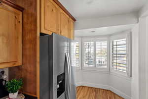 Kitchen featuring newer refrigerator with ice dispenser and breakfast nook.