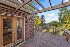 Deck off semi-formal dining area with built-in seating and stairs leading down to spacious backyard.