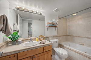 Bath down with a jetted tub and customer tile.