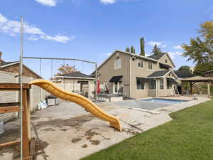 Back of house with a patio, a gazebo, stucco siding, and a jacuzzi