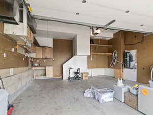 Garage featuring a workshop area and a garage door opener