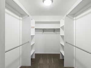 Walk in closet featuring dark carpet