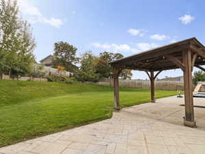 Surrounding community featuring a fenced backyard, a patio area, and a gazebo