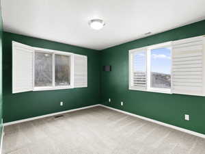Carpeted empty room with baseboards