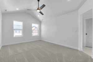 Spare room featuring light carpet, vaulted ceiling, ceiling fan, a textured ceiling, and recessed lighting