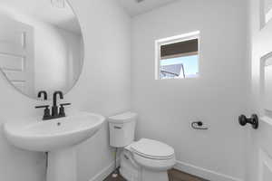 Bathroom with baseboards and dark wood-style floors