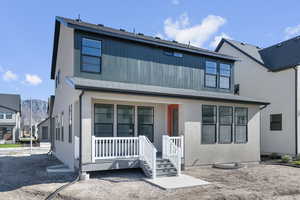 View of front of property with covered porch, a mountain view, and roof with shingles