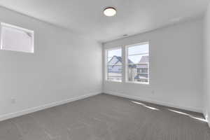 Unfurnished room featuring carpet flooring and baseboards