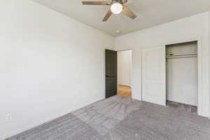 Bedroom featuring carpet floors, a closet, and a ceiling fan