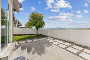 Fenced backyard with a patio area and a mountain view