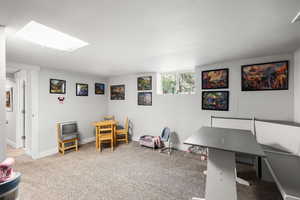 Playroom featuring carpet floors and a skylight