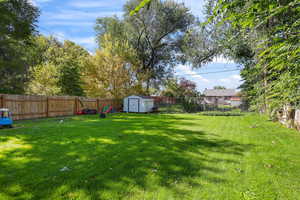 Fenced backyard with a storage unit