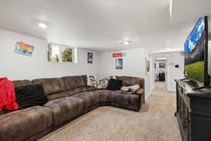 Living room featuring light colored carpet and baseboards