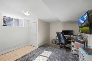 Office area with light tile patterned floors and baseboards