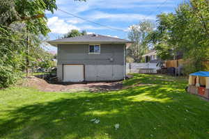 Rear view of property with brick siding