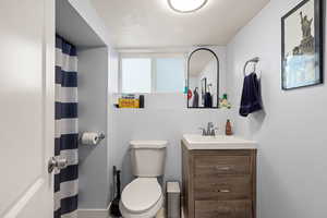 Bathroom featuring vanity and curtained shower