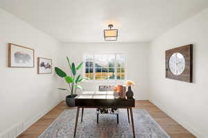 Home office with light wood-style floors