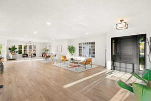 Entrance foyer featuring wood finished floors, recessed lighting, and a textured ceiling
