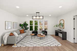 Living room with recessed lighting and light wood-style floors