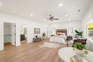 Bedroom featuring recessed lighting, light wood finished floors, a spacious closet, and a ceiling fan