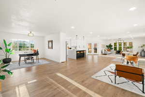 Living area featuring light wood-style flooring, french doors, and recessed lighting