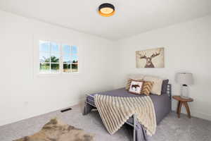 Carpeted bedroom featuring baseboards