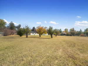 View of green lawn featuring a view of rural / pastoral area