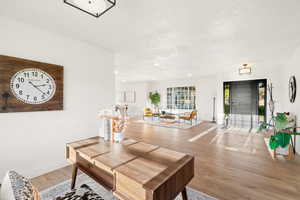 Living area featuring light wood finished floors and recessed lighting