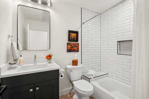 Full bathroom with shower / bath combo with shower curtain and vanity