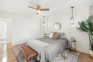 Bedroom with light wood-style floors and ceiling fan