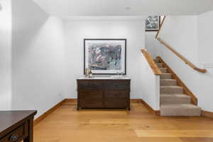 Staircase featuring wood finished floors and baseboards