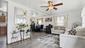 Living area featuring wood finished floors and a ceiling fan