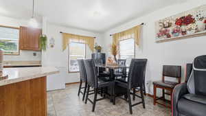 Dining room featuring plenty of natural light and light tile patterned flooring